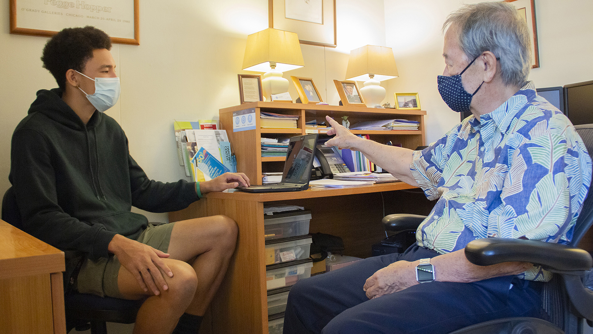 Counselor advising student in office