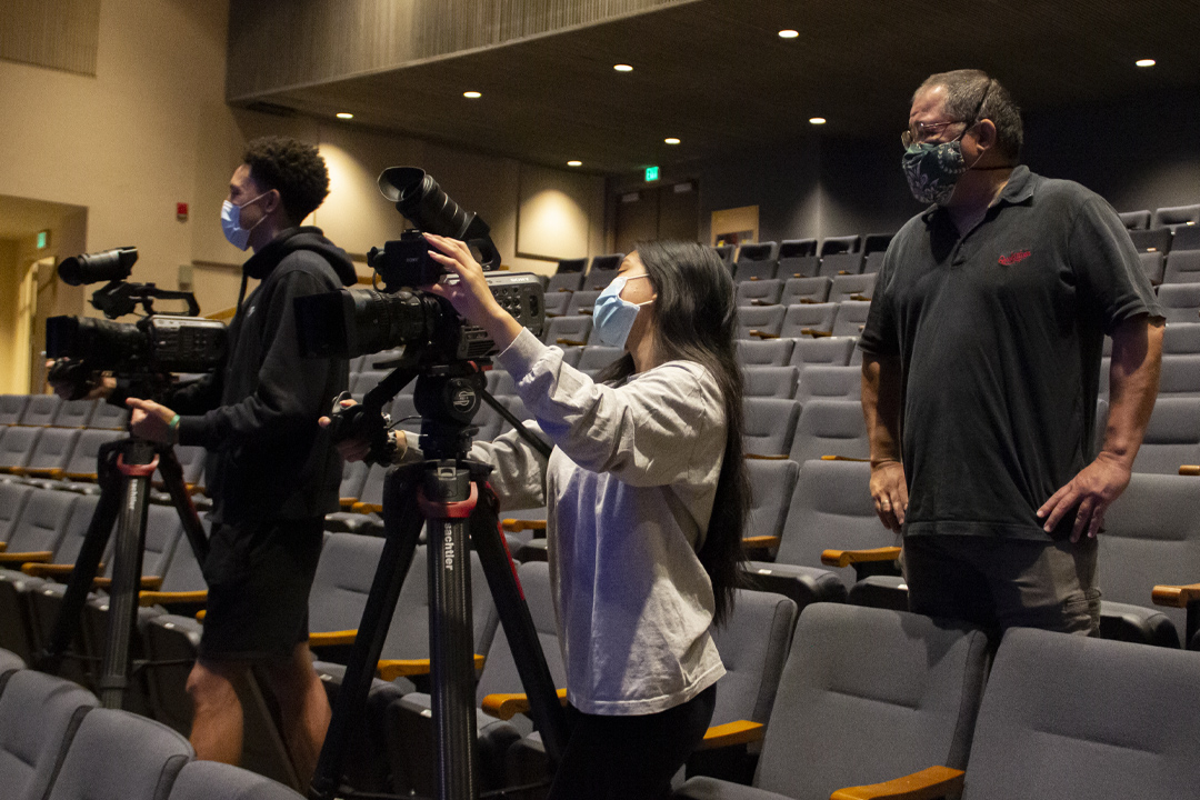 EMC staff setting up cameras in theatre